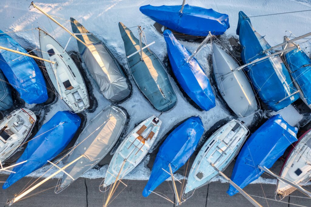 Aerial shot of sailboats in winter storage wrapped in protective coverings in Lake City, MN.